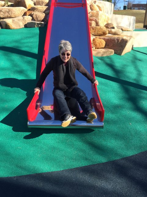 Rama sliding down a slide at Durham Central Park
