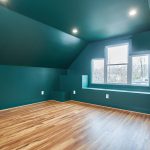 Renovated attic with hardwood floors and green walls
