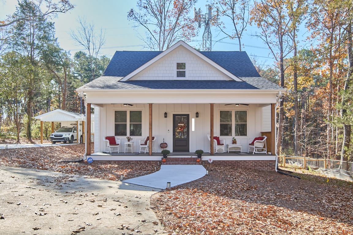 Head-on exterior photo of small white house.